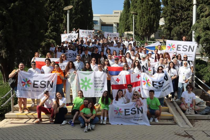 A very large group of all volunteers holding ESN flags from their countries