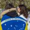 A photo of two people from the back wrapped in flags.