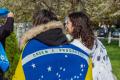 A photo of two people from the back wrapped in flags.